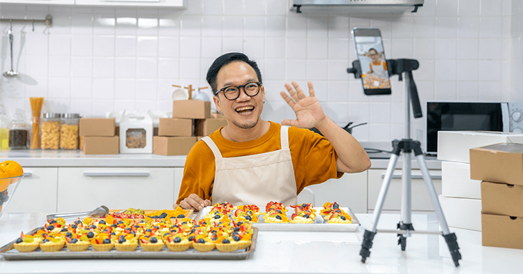 Small business owner creating a video of baked goods for content marketing
