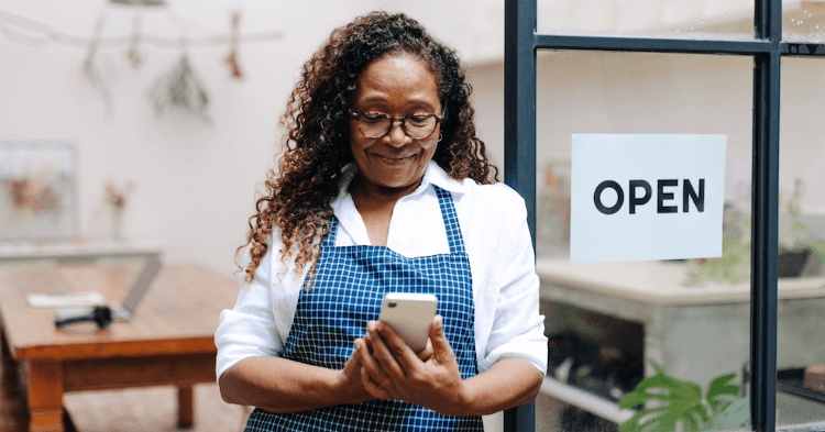 Small business owner looking at her website on a phone