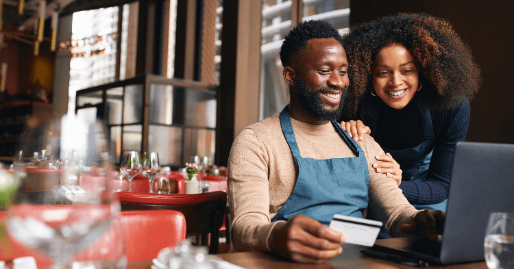 Business owners reviewing business credit on a laptop