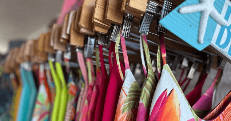 Close-up of bathing suits on a rack.