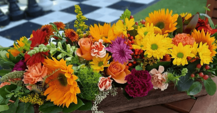 Bouquet of yellow, orange, pink, purple, and red flowers.