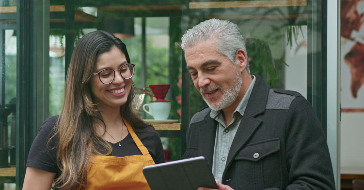 Man talking to his employee and holding a tablet