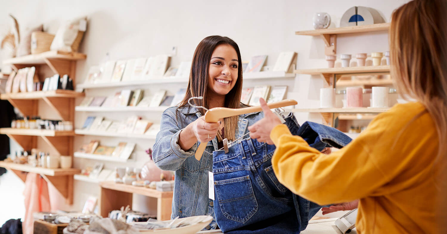 Small business owner helping a customer shop.